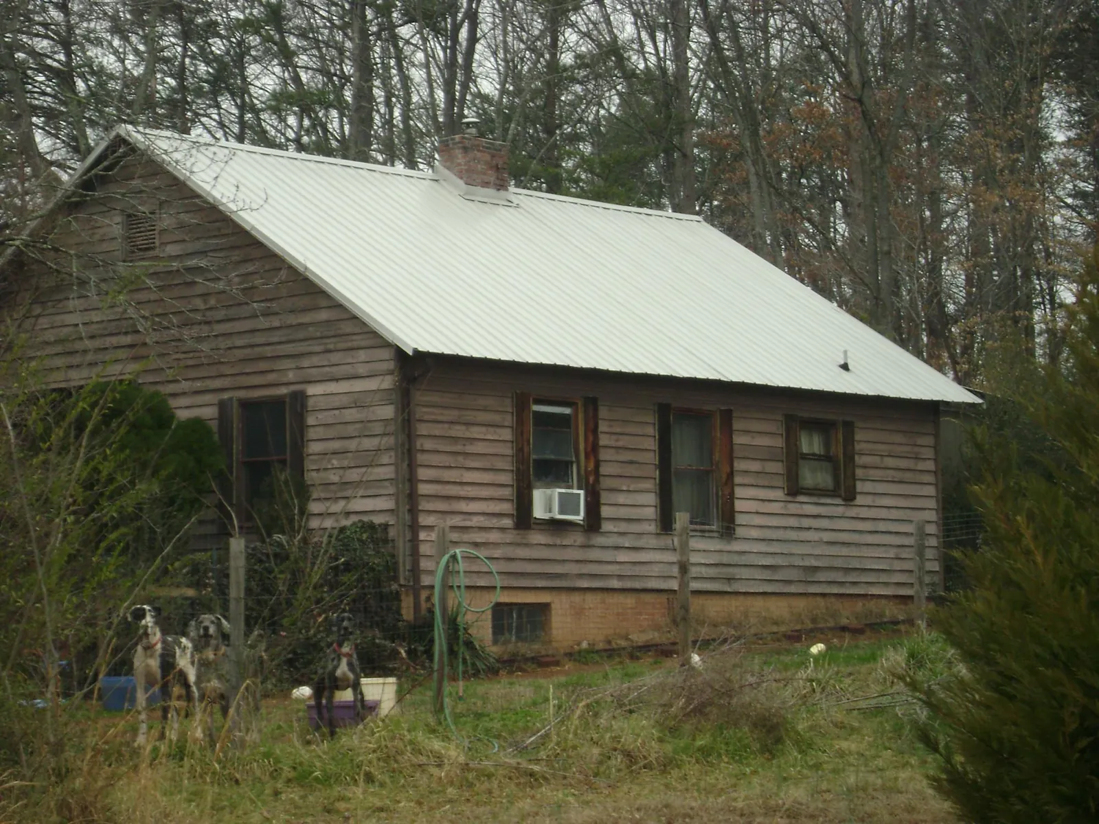 White metal roof on an old wood sided farmhouse, from a Metal Roof Installation job in Hadley